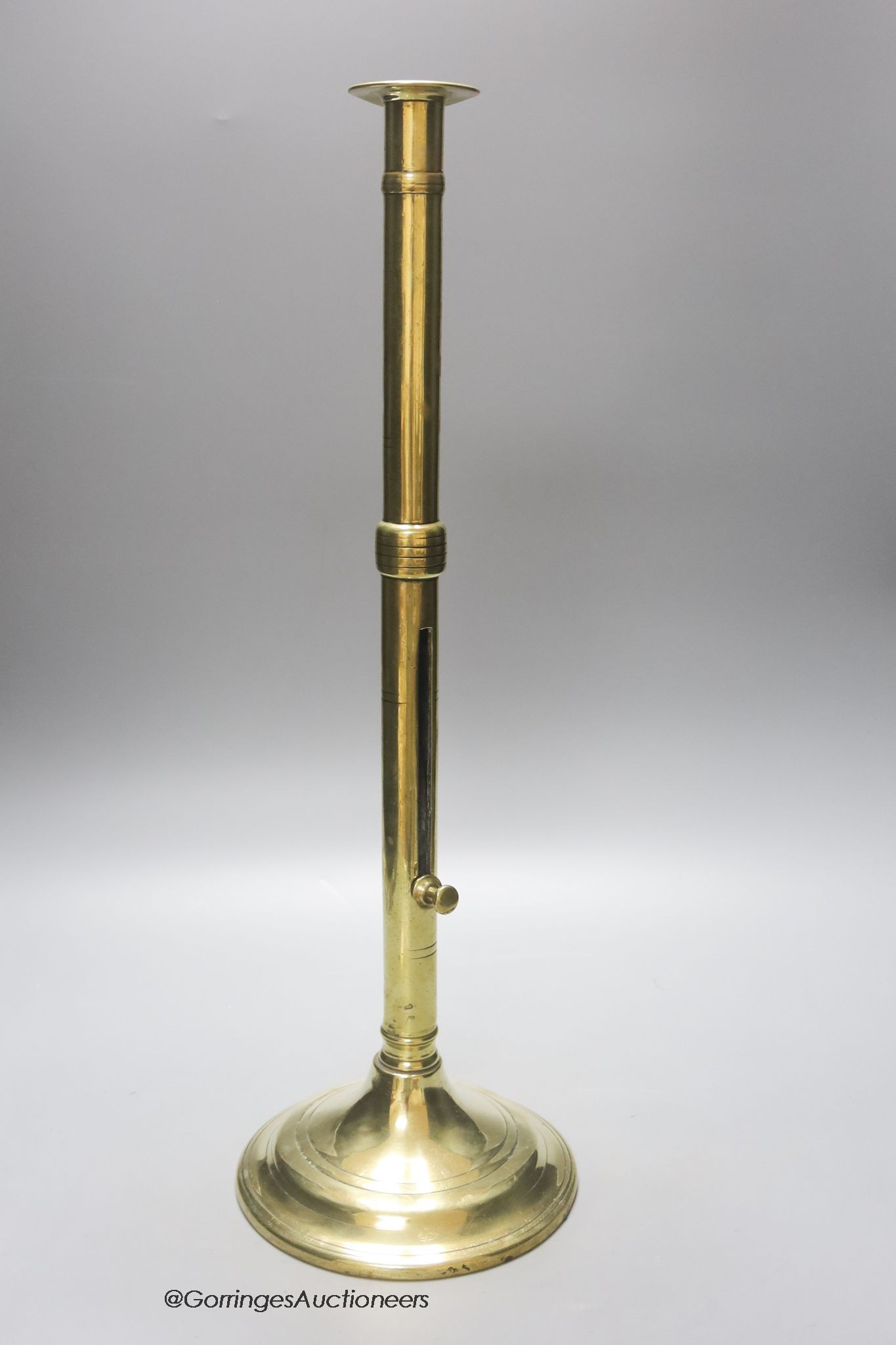 A 18th century brass ejector candlestick, height 50cm